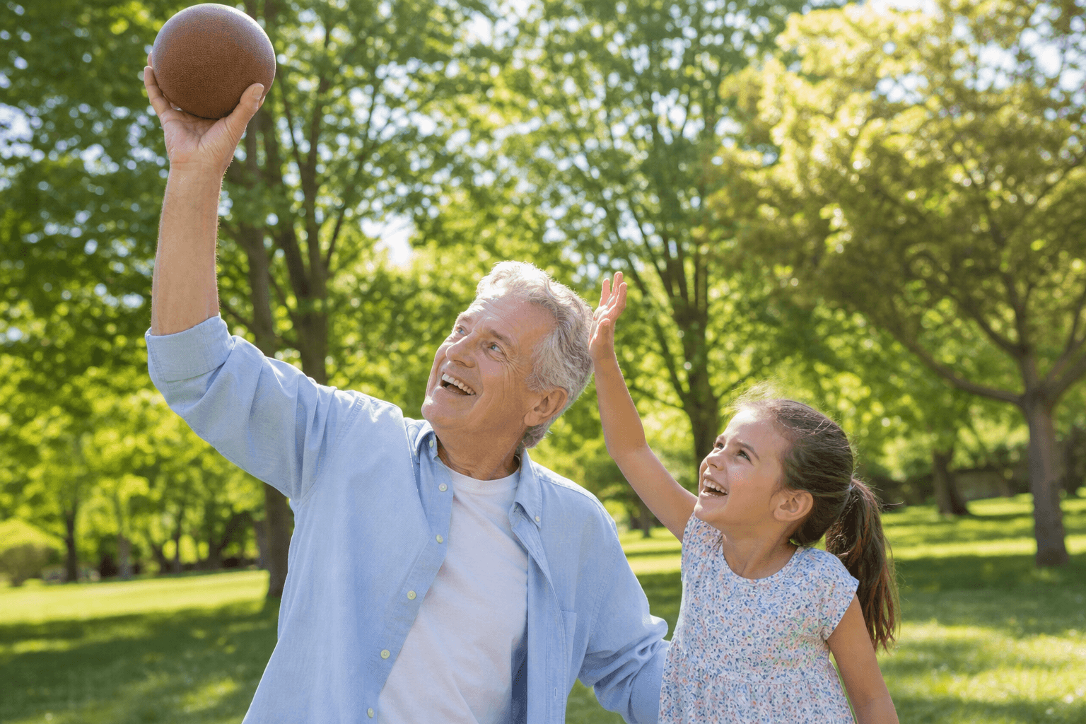 Grandfather playing with his granddaughter in a park