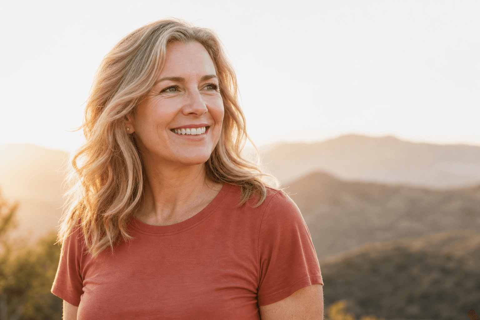 Smiling woman outdoors after shoulder replacement recovery